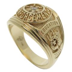 Our Texas Law Enforcement class-style ring shown in 14k yellow gold with center set gemstone.